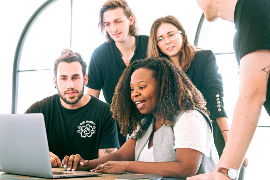 People in an office looking at a computer