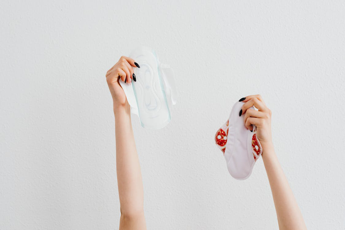 A woman holding sanitary napkins