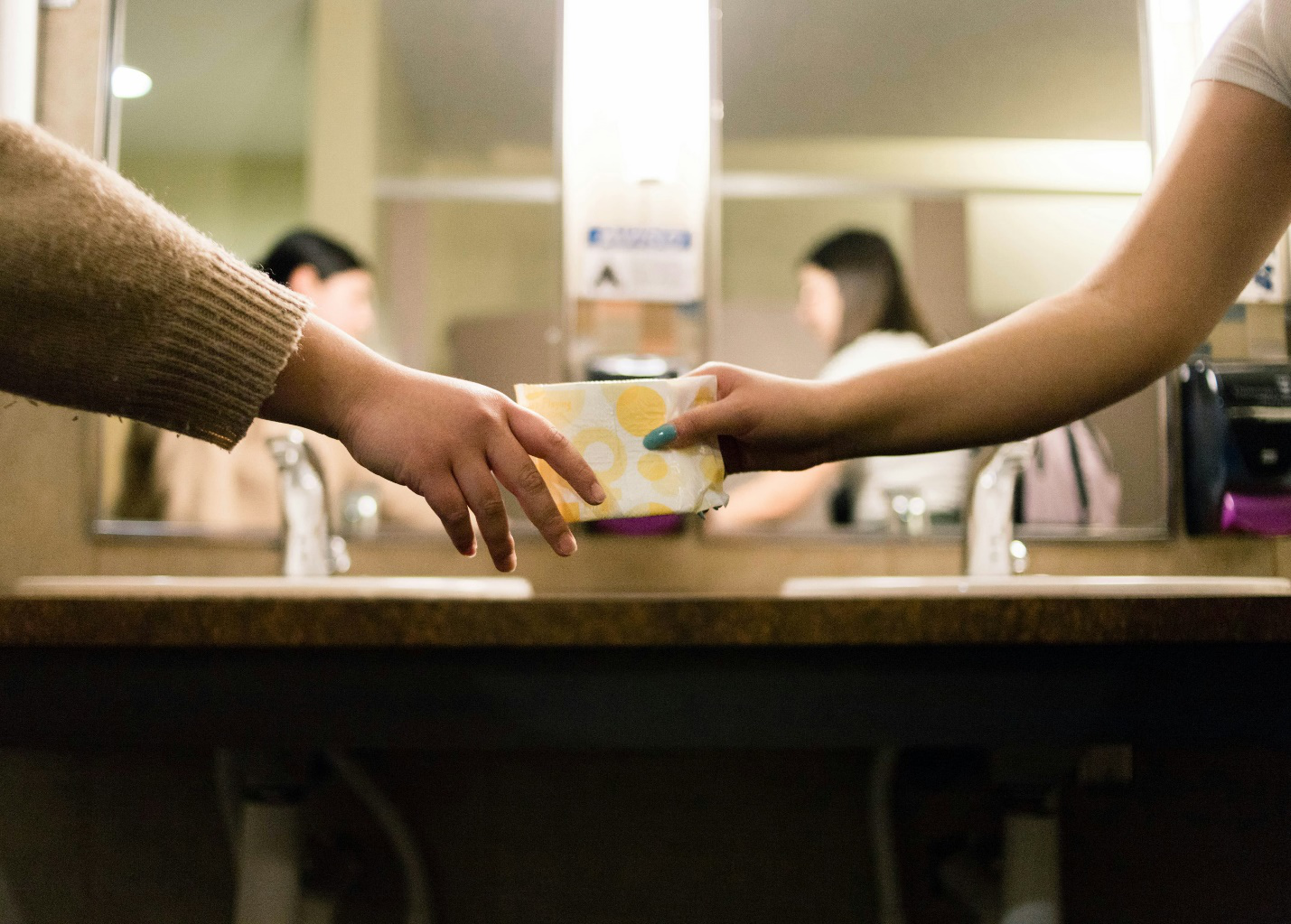 Two people holding a pad