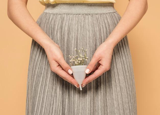 Close-up of a menstrual cup with flowers.