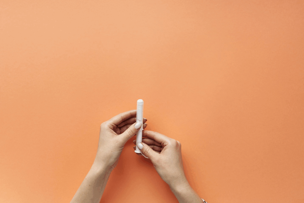 Woman holding a tampon