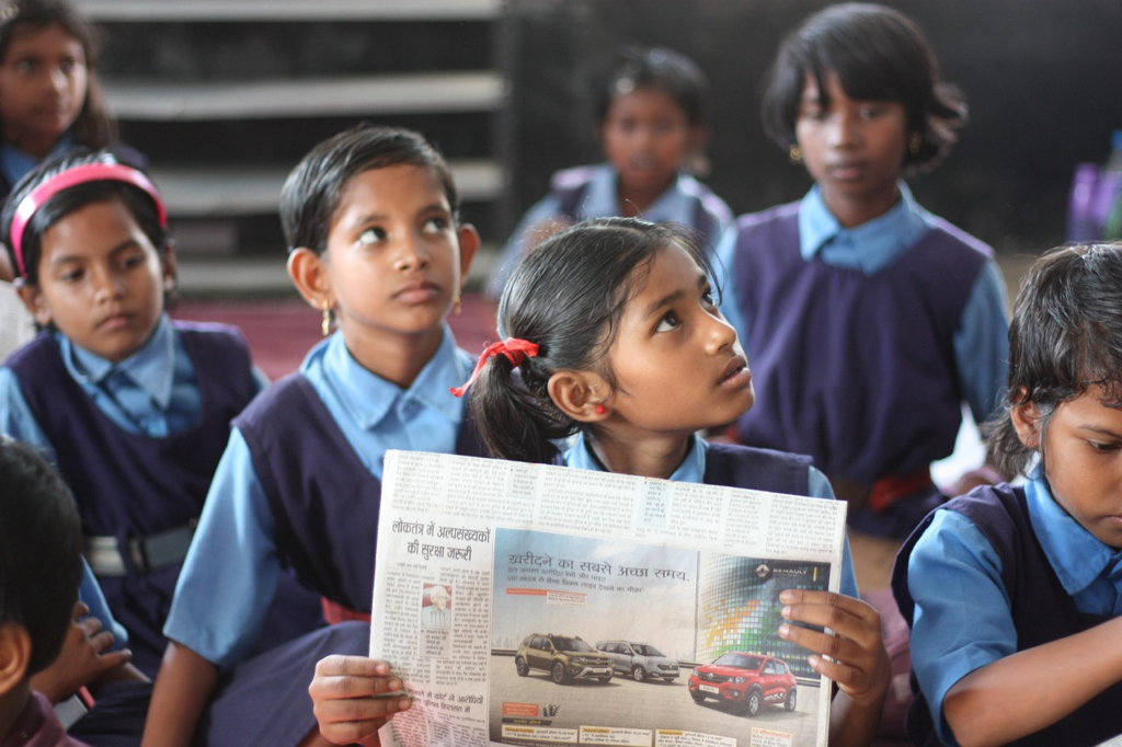 a classroom of young girls being taught about menstruation