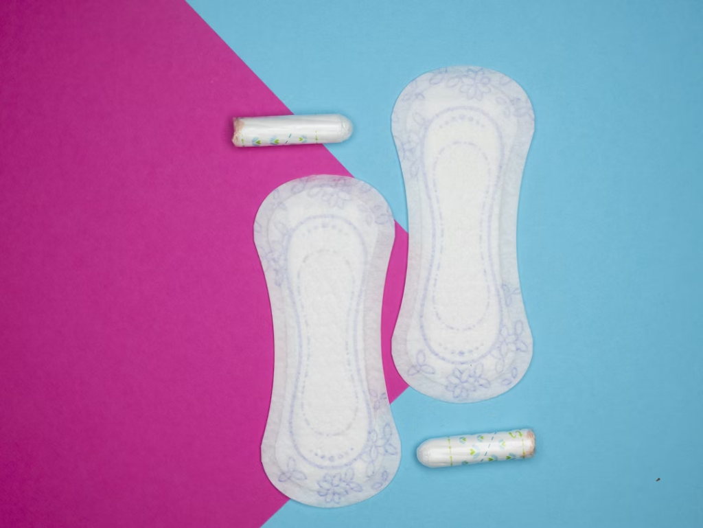 two pads and tampons on a blue and pink background