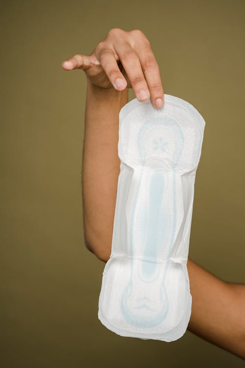 a woman holding a sanitary pad