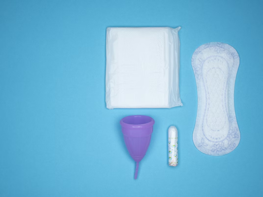 different menstrual products placed on a blue surface