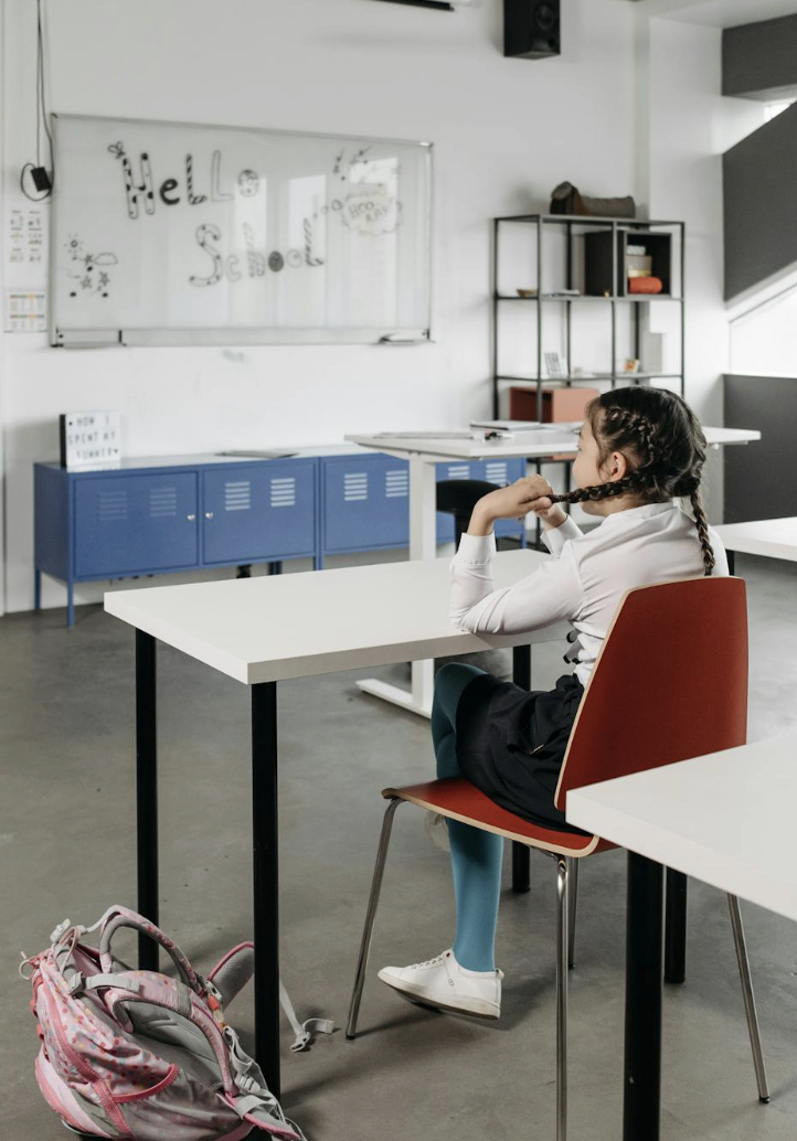 This photo shows a group of school girls sitting in a classroom during a workshop.